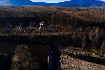 Carpathian village in Ukraine, autumn view of the village, river and mountains from a bird's eye view, aerial photography of the Carpathian region.