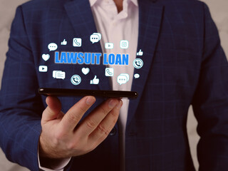  LAWSUIT LOAN text in search line. Broker looking at smartphone. A lawsuit loan is a cash advance against a future lawsuit judgment or settlement award.