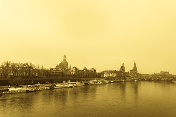 Fototapeta na wymiar A classical view of Dresden city in sepia tone. Taken early morning in a misty weather, slightly blurry due to fog.