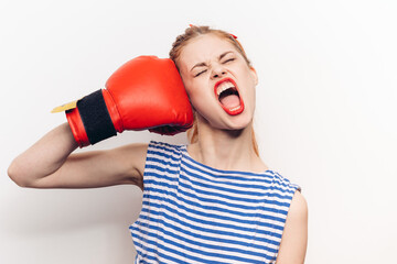 red-haired woman in striped t-shirt and boxing gloves in workout emotions