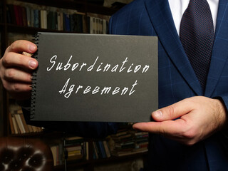 Business concept meaning Subordination Agreement with sign on the black notepad.