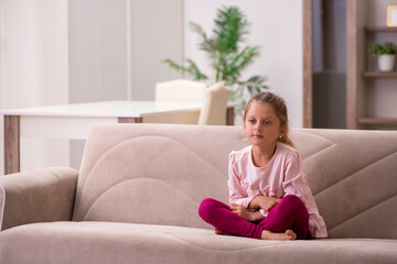 Fototapeta premium Small girl staying alone at home