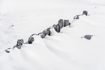 old wooden mole frozen in winter