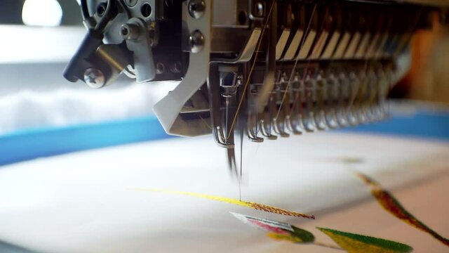 textile industry.modern industrial embroidery machine applies pattern on fabric.