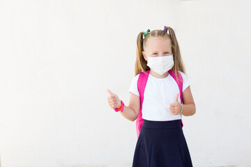 girl with a backpack in a mask.School