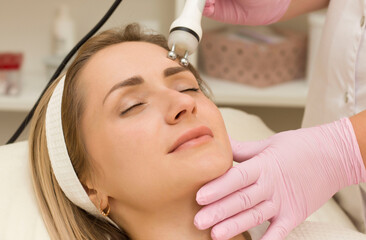 portrait of a young beautiful girl rf face lifting procedure. Face care and rejuvenation. Increased...