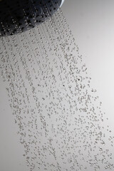 Naklejka na ściany i meble Shower head and flying water drops.