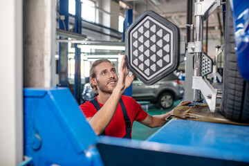 Man doing car repair in garage
