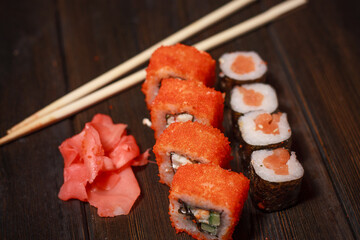 asian cuisine sushi and rolls on the table wooden sticks ginger wasabi
