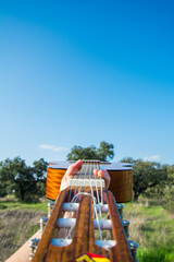 Creative Photography Of A Hand Holding A Spanish Guitar With Nature Background. Spanish Classical Guitar Exterior. Music And Nature