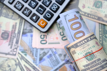 Calculator with banknotes money background and finance and investment concepts