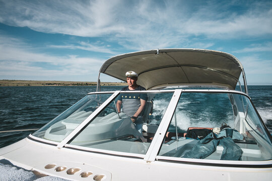 Almaty. Kazakhstan.26.05.2020.the captain of the yacht at the helm controls the boat on the water