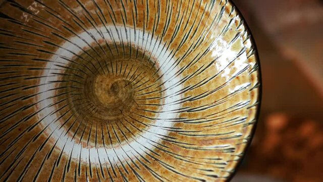 Close up of Japanese handmade spiral pattern plate and pottery at Ontayaki pottery village in Kyushu, Japan. The mountain village of Onta.