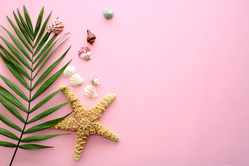 Pink summer background with palm leaves, seashells and starfish, frame with copy space, flat lay