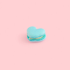 Heart shaped macaroon biscuit on pastel pink background