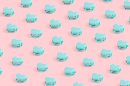 Heart shaped macaroon biscuits on pastel pinky background