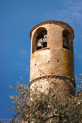Old medieval tower. Typical Italian construction with bells in Pozzolengo (Italy)
