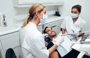 Fototapeta premium Dental doctor treating patient in clinic