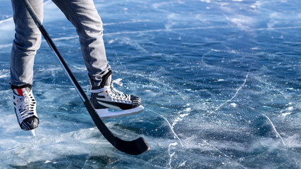 A man in a skate with a stick in his hand on the ice. Baner with a place for text