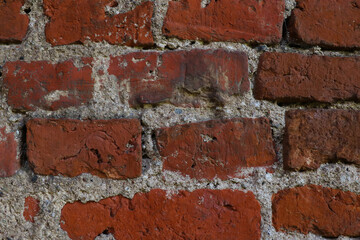 The wall of an old red brick building.