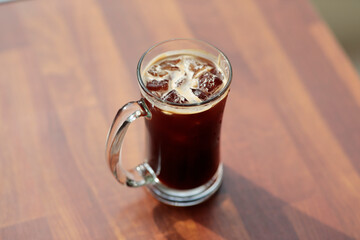 glass of drink on wooden table