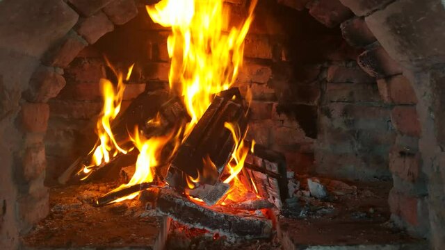 Video of wood burning fireplace. antique stone fireplace. Fire is burning in the fireplace. Hearth. Warmth and home comfort. Flames of a village house.