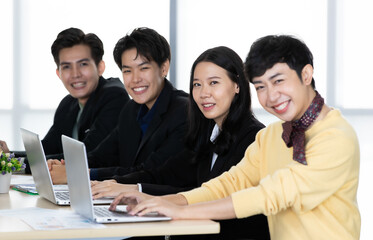 A group of multi-sex colleagues businesspeople, tomboy and transgender gay, working together with...