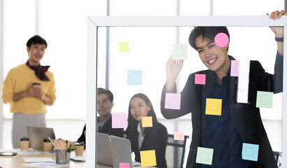 A cheerful and joyful transgender tomboy businessman standing and explaining the idea and work...