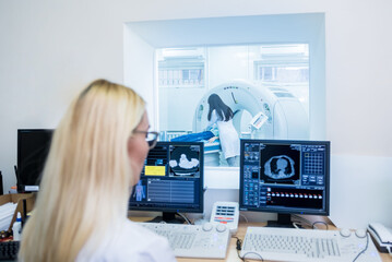 Radiologist in the control room of computed tomography at hospital