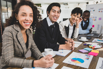 Business men and women sitting of diversity nationalities and ethnicities were laugh and smiling before the start of the meeting to create an atmosphere in the meeting room at the office. 