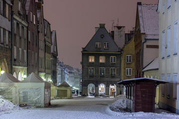 Olsztyn old town in winter at night - tenement houses in the old town