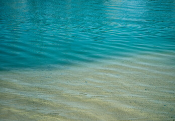 Soft waves of blue sea on sandy coast. Mediterranean sea.