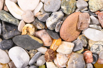 Rock pebbles background or dry stone pebbles texture. High resolution macro close up for your design.