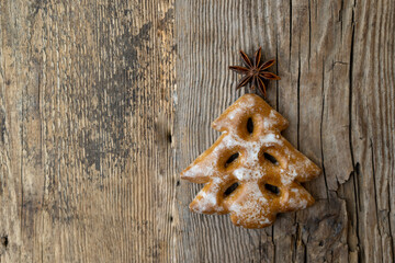Christmas tree cookies on wooden background. New Year's food. Anise star. Festive baked goods. Gingerbread on the table.Icing sugar sweetness taste season