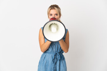 Young Russian woman isolated on white background shouting through a megaphone to announce something