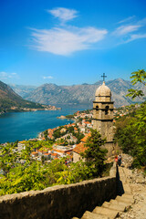 View on Church, ancient walls, mountains and sea in Kotor old town. Montenegro, Kotor bay