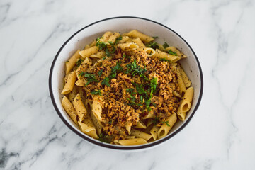 vegan penne pasta with plant-based meat and lemon sauce, healthy plant-based food
