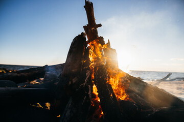 sunset  bonfire burning on the beach