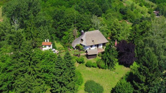 Traditional rural house with a thatched roof in Podravina region of Croatia 