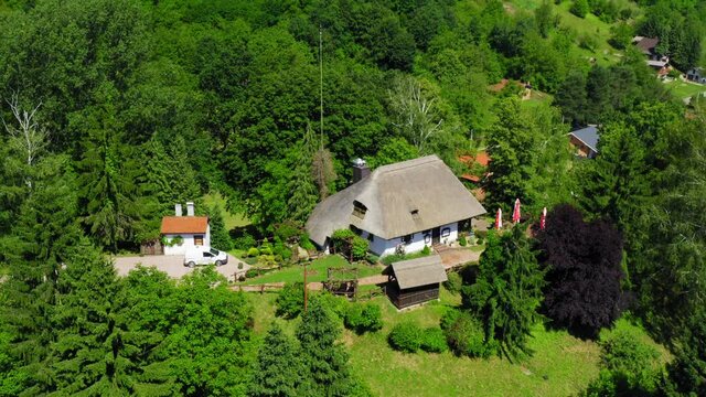Traditional rural house with a thatched roof in Podravina region of Croatia 