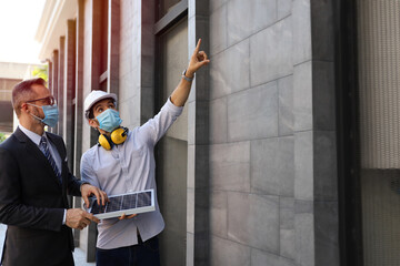 Business people wear face mask and meeting and talking with engineer and architecture about...