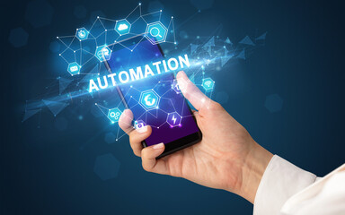 Female hand holding smartphone with AUTOMATION inscription, modern technology concept