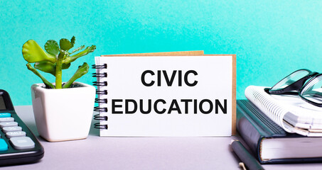 CIVIC EDUCATION is written on a white card next to a potted flower, diaries and calculator. Organizational concept