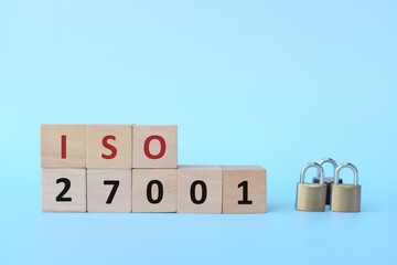 ISO 27001 on wooden blocks with padlock. Information security management system concept.