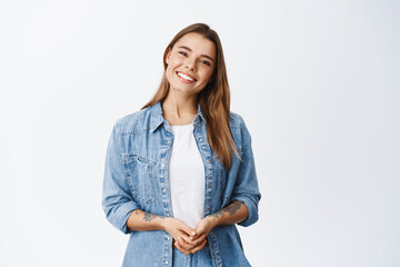 Beautiful smiling woman looking friendly and ready to help customer or client, holding hands...