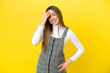 Young caucasian woman isolated on yellow background laughing