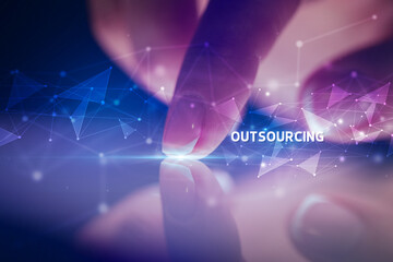 Finger touching tablet with OUTSOURCING inscription, business concept
