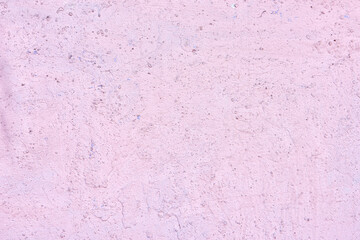 The texture of an old pink plaster wall. Close-up, pattern.
