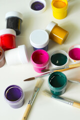 top view of painting tool, gouaches and painting brushes