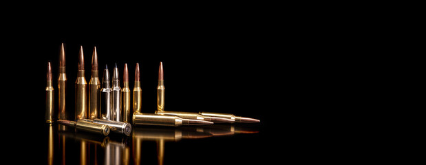 Bullet isolated on black background with reflexion. Rifle bullets close-up on black back....